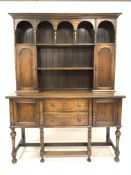 18th century style oak dresser, two open shelves over two arched panelled cupboards, fitted cutlery