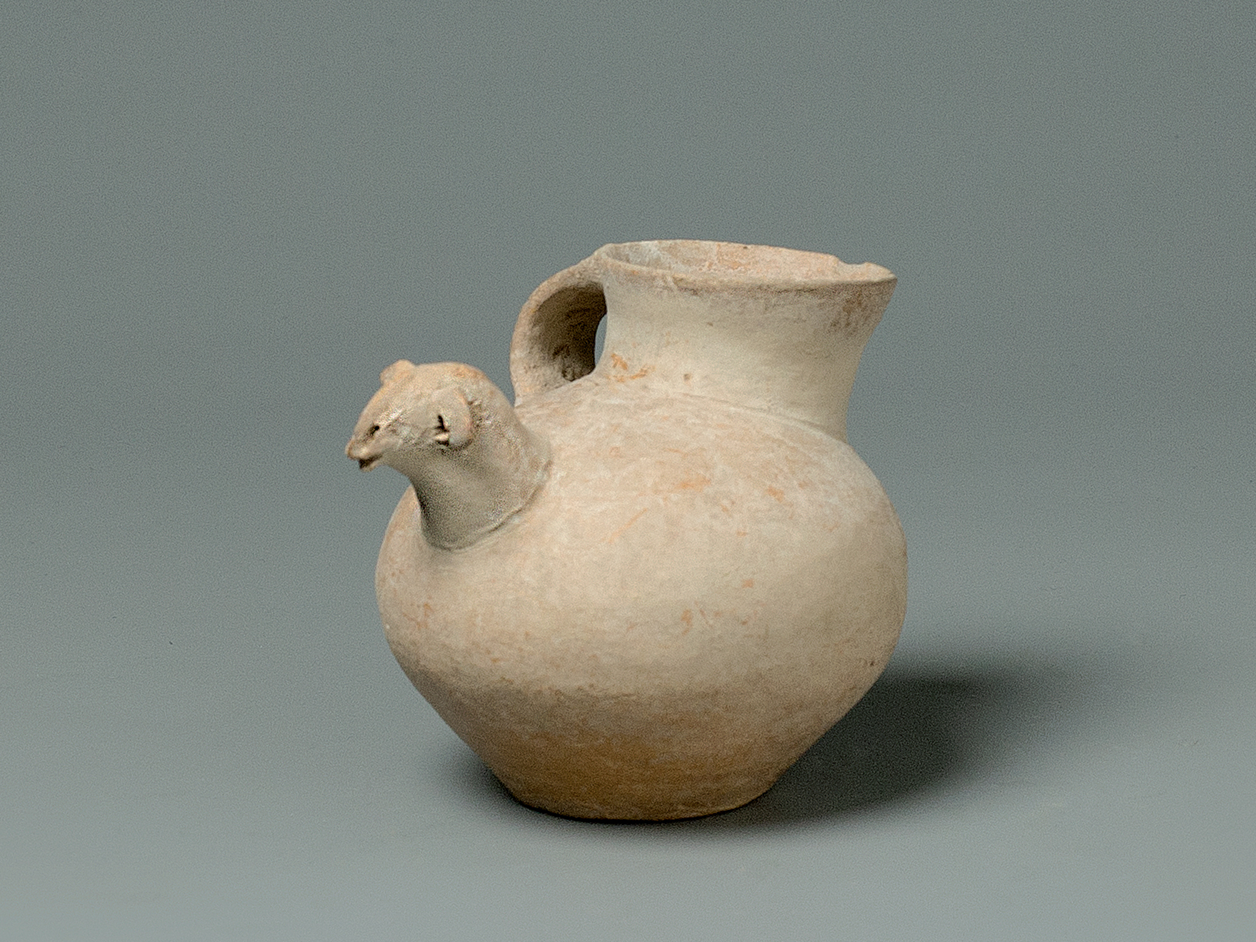 A Red Pottery Vase With Ram’s Head Handle, Gansu Province, Qijia Culture (2050-1700 Bc)