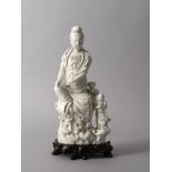A White-Glazed Figure of 'Guanyin and Child', 19th Century