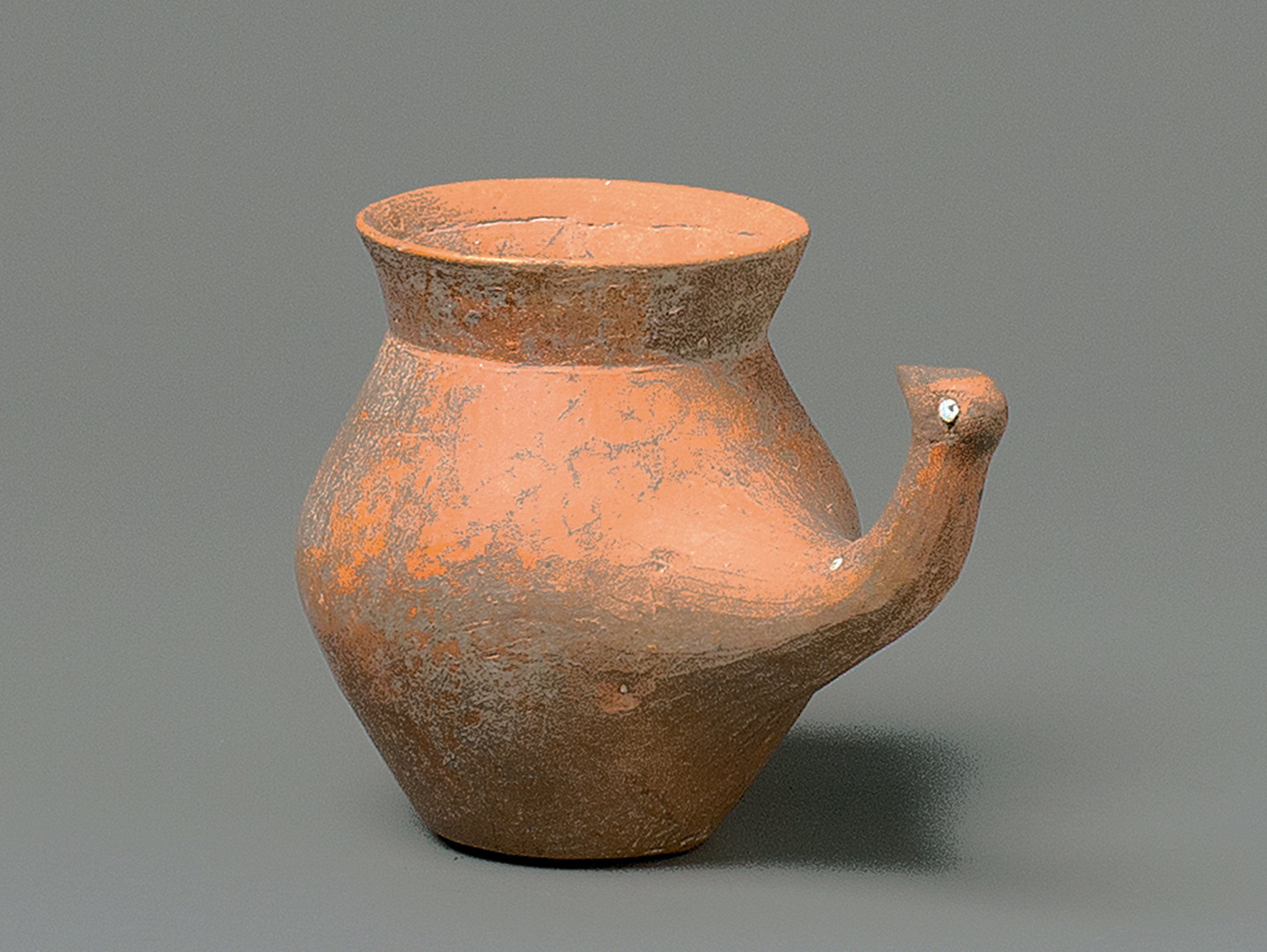 A Burnished Red Pottery Jar With A Bird-Head Handle, Gansu Province, Qijia Culture (2050-1700 Bc)