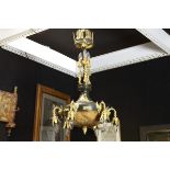 Empire style chandelier in patinated brass and guilded bronze with a central bowl in [...]