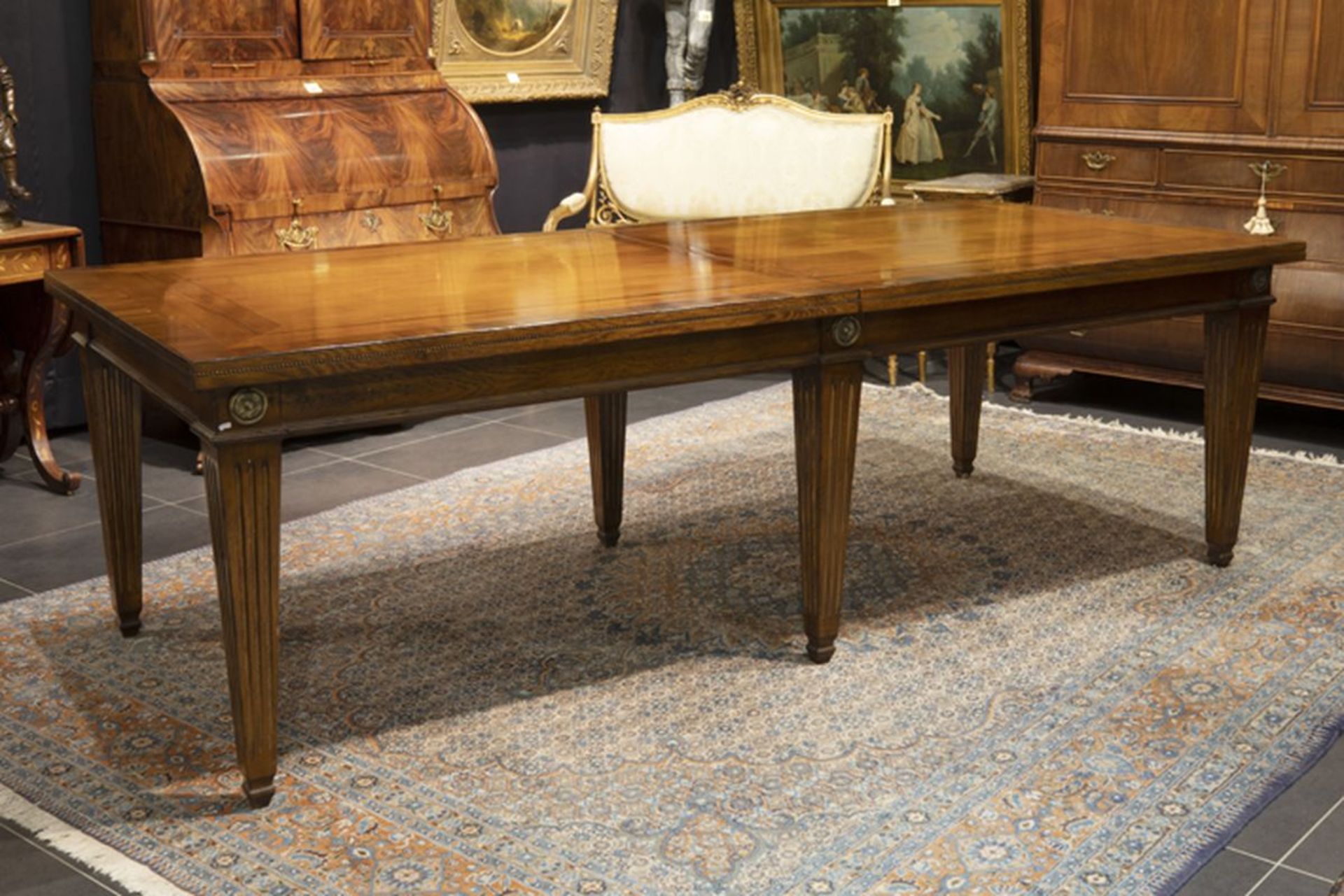 quite large neoclassical table in walnut and fruitwood with an extendable top on six [...]