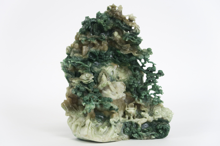 Chinese jade sculpture with a animated landscape with a reading god in a cave - - [...]