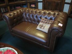 Brown leather effect two seater Chesterfield sofa. Please ensure sufficient resource / handling aids