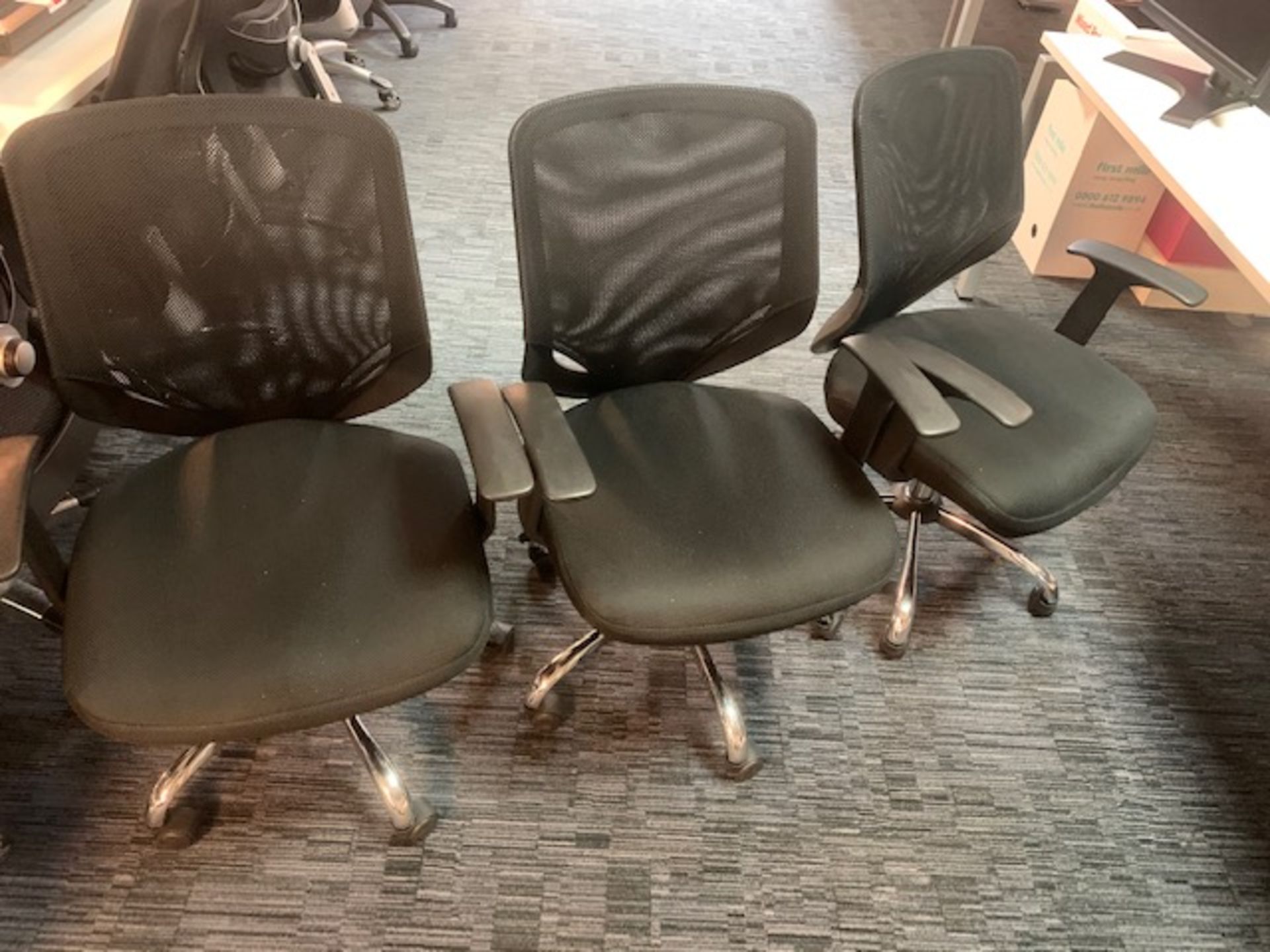 Three black cloth with mesh back swivel & tilt office chairs with chrome legs