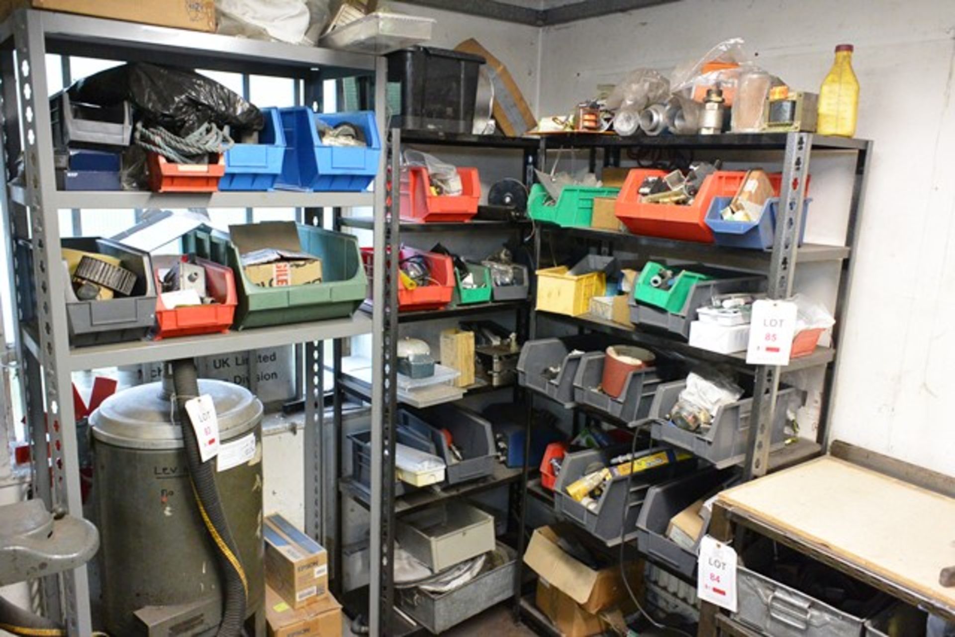 Three bas of stores racking and contents, to include assorted spares, lighting, fuses, filters, etc.