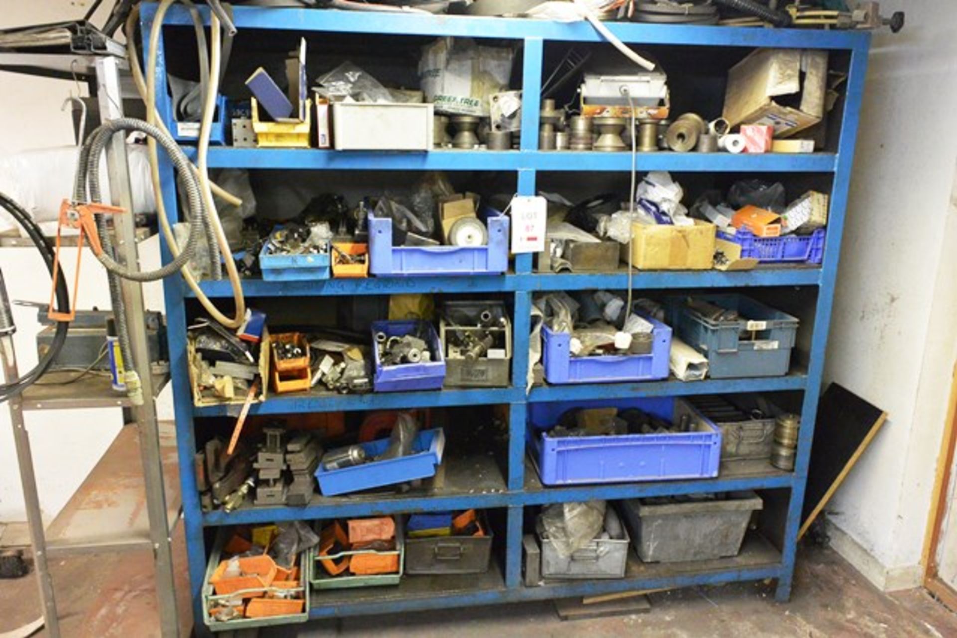 Bay of stores racking (welded) and contents, to include assorted machine spares, belts, etc.