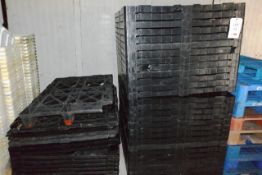 Large quantity of black plastic pallets (including throughout site)