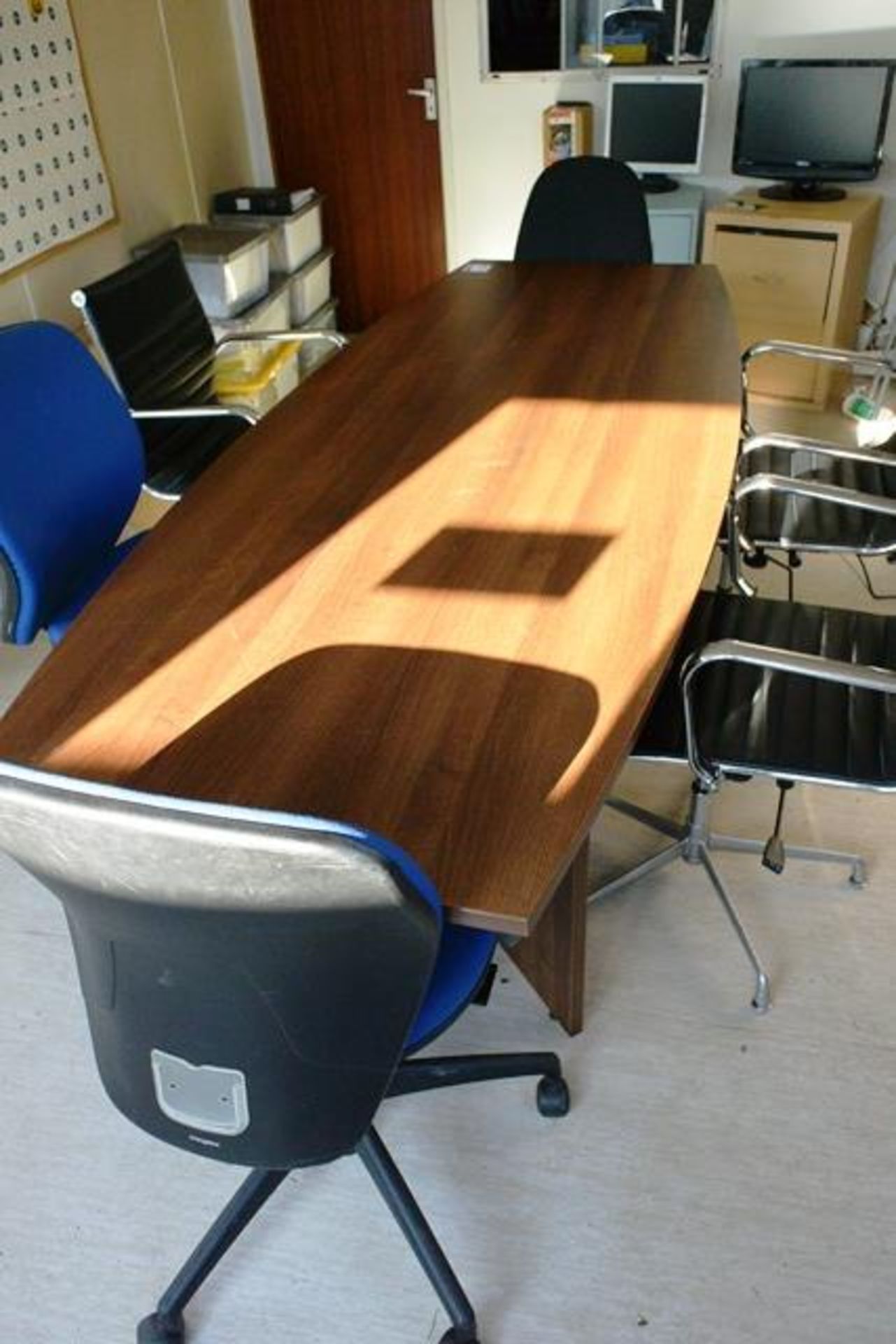 Dark wood boardroom table, with six various office swivel chairs