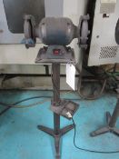 Unbadged 6" double ended bench grinder mounted on pedestal stand