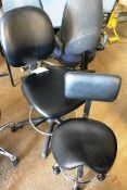 Two black leather effect mobile chairs