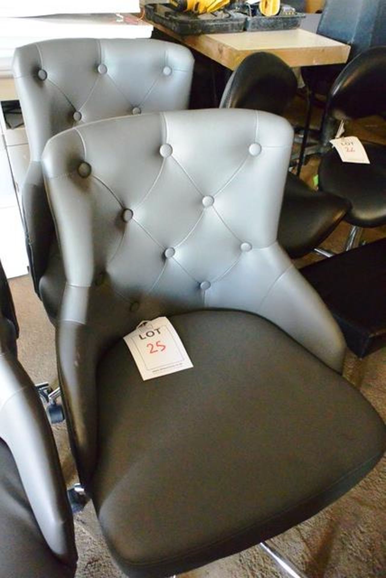 Two grey leather effect, mobile chairs