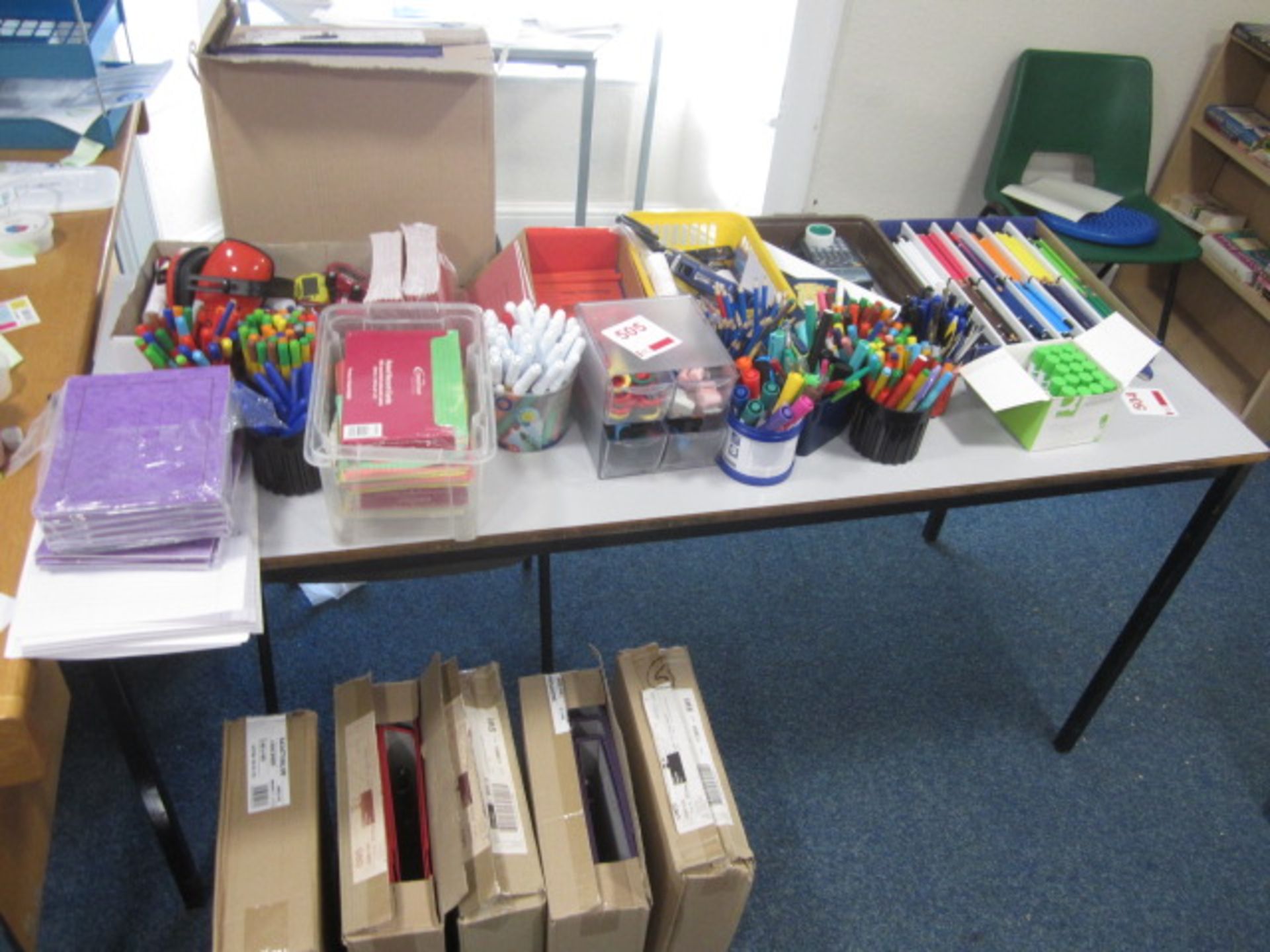 Assorted sundries including coloured pencils, pens, glue sticks, record cards, school exercise