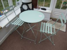 2 x metal circular folding bistro tables with 4 x metal slatted chairs. Located at main school