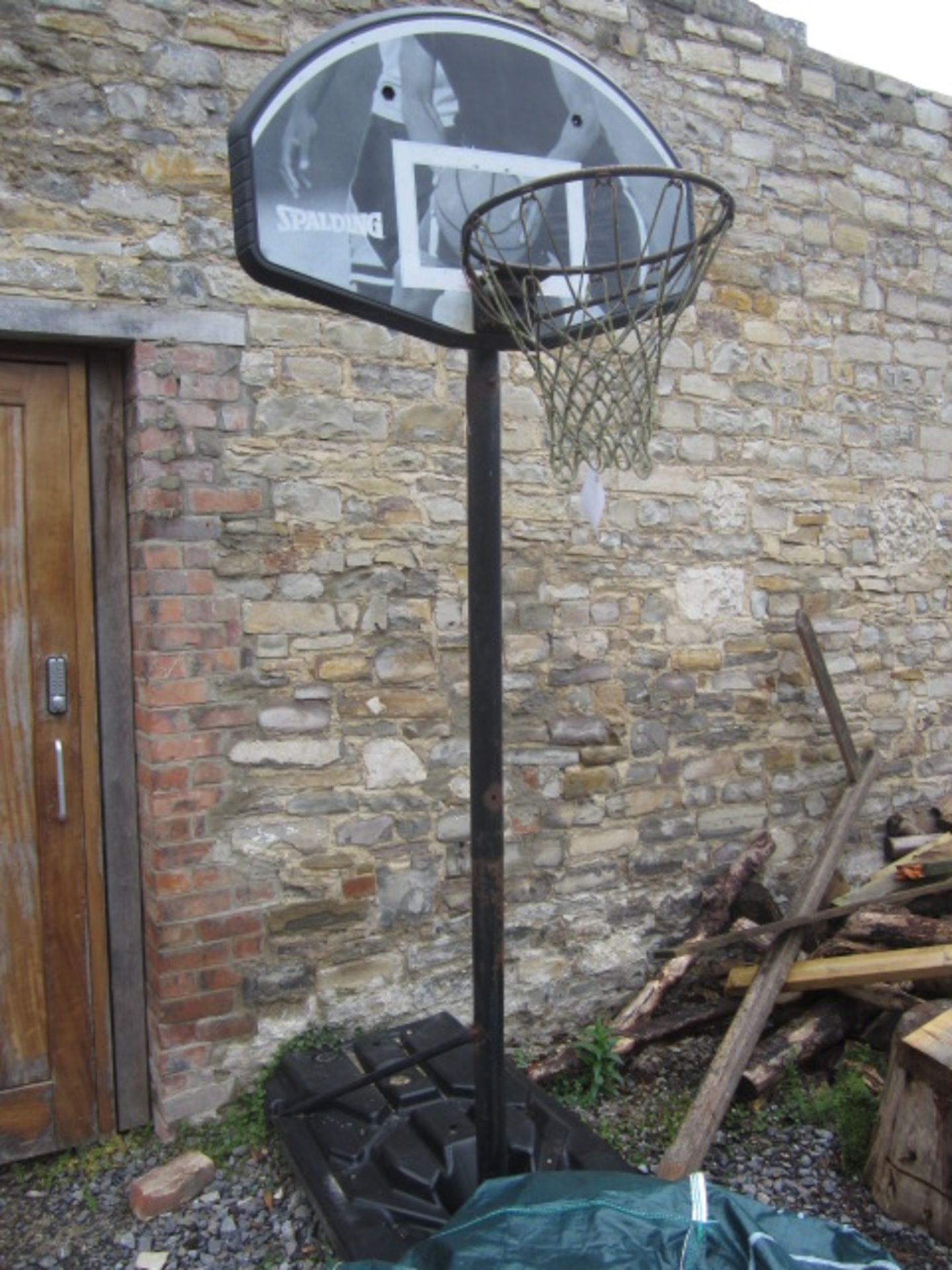 Spalding basketball hoop with water fill base. Located at main schoolPlease note: This lot, for