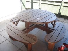 Timber slatted circular picnic table and bench seating. Located at main schoolPlease note: This lot,