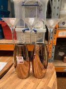 Three large martini glasses, two tall gold textured vases