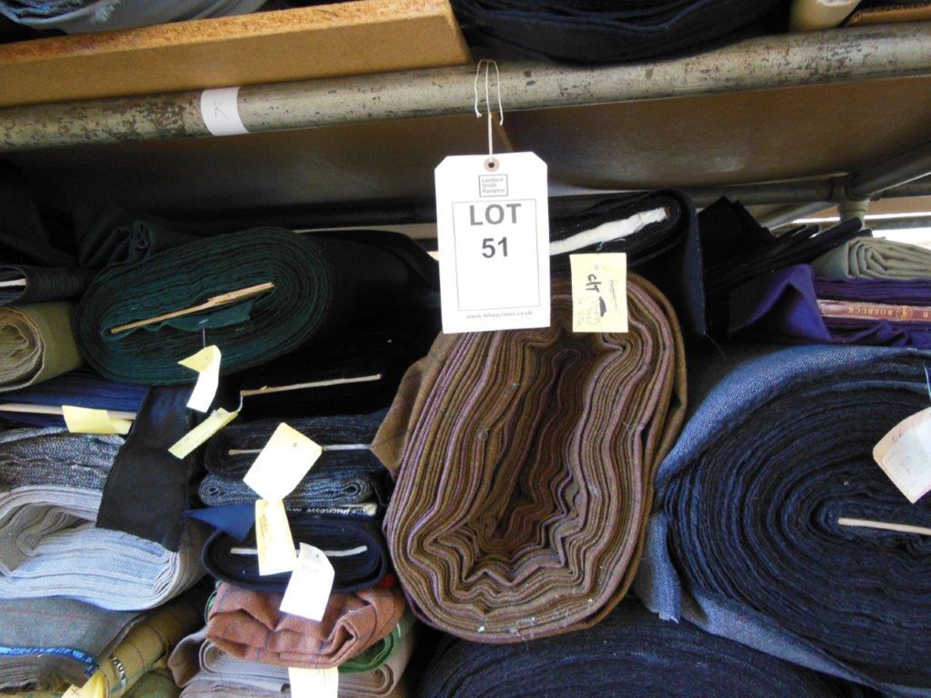 Large quantity of assorted fabrics including tweed, wool and cotton, in 3 bay steel keyway rack
