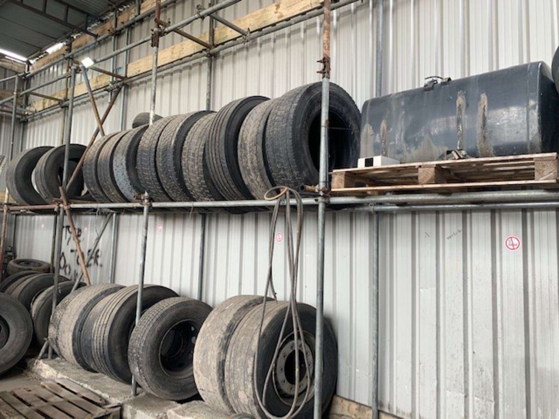 Contents of shelves to include fuel tank, various part worn tyres, lorry rims,and various other