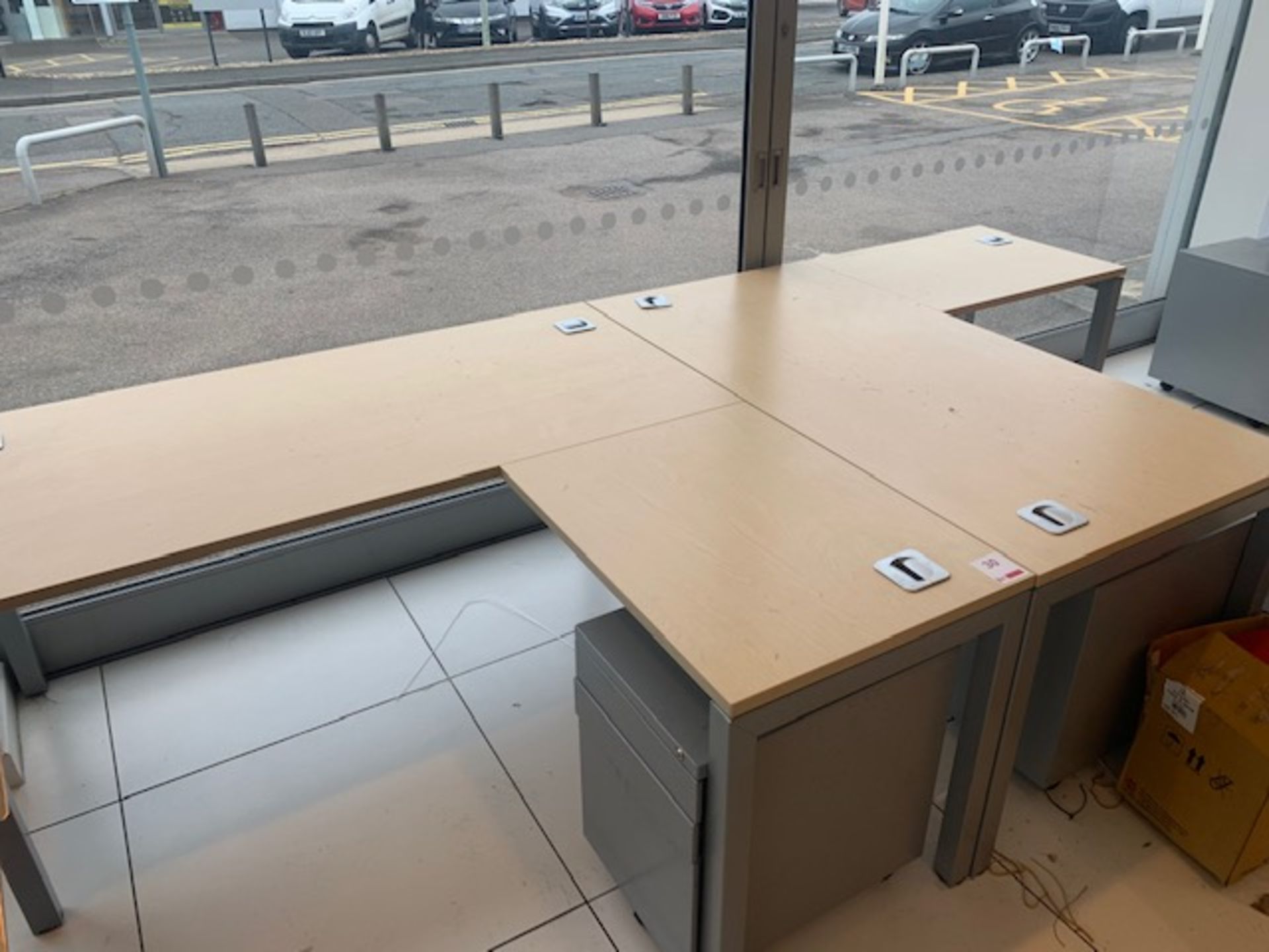 Two light oak L shaped desks c/w two metal pedestals