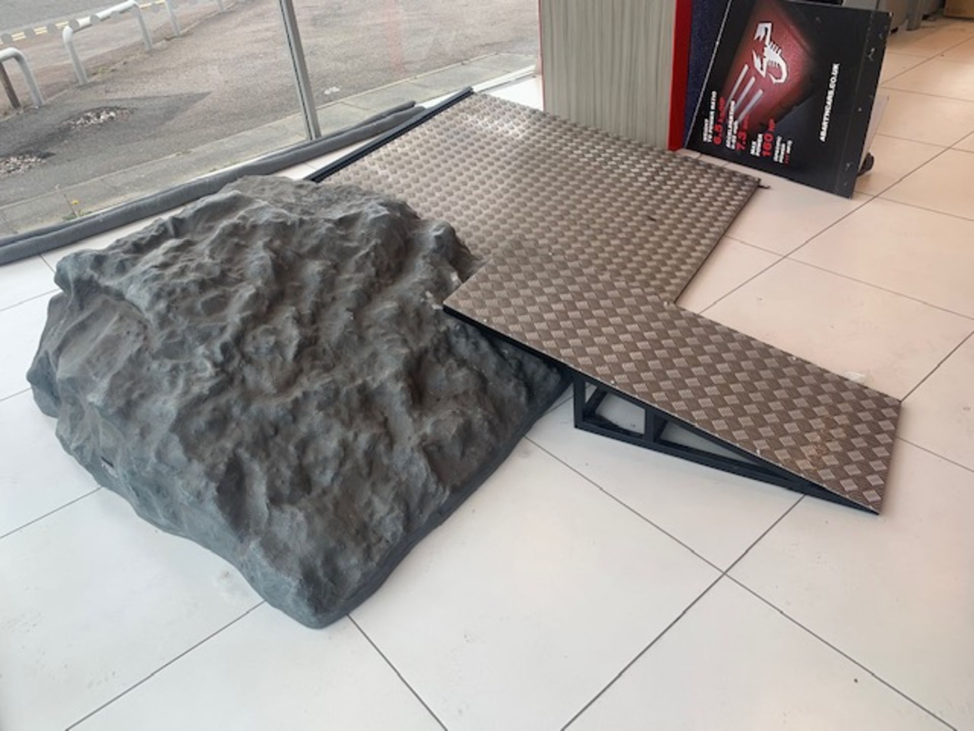 Two vehicle display ramps c/w ornamental rockery section