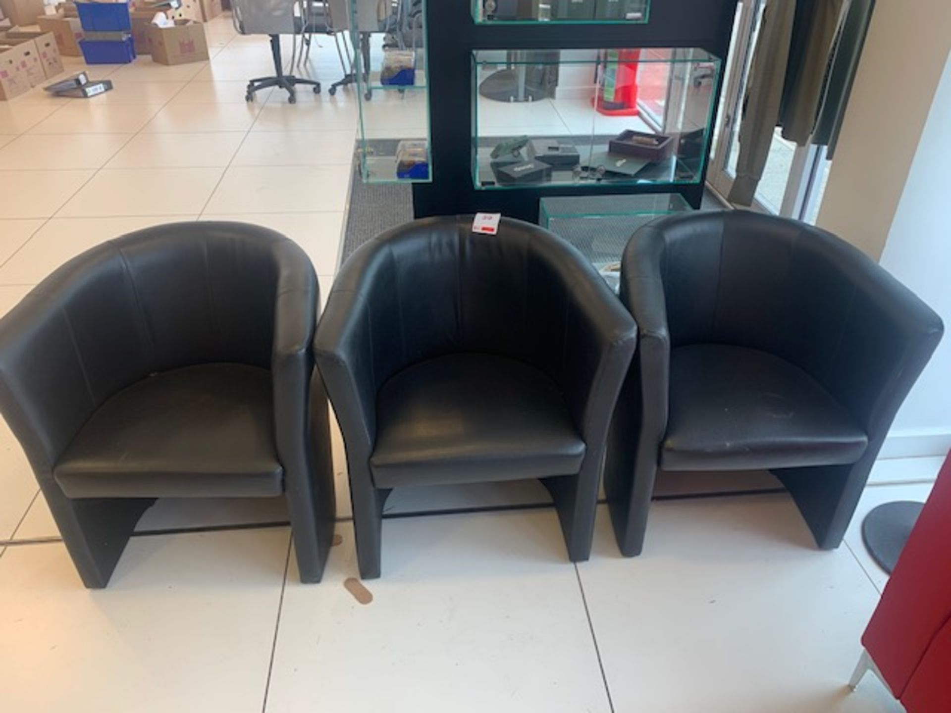 Three leatherette tub chairs