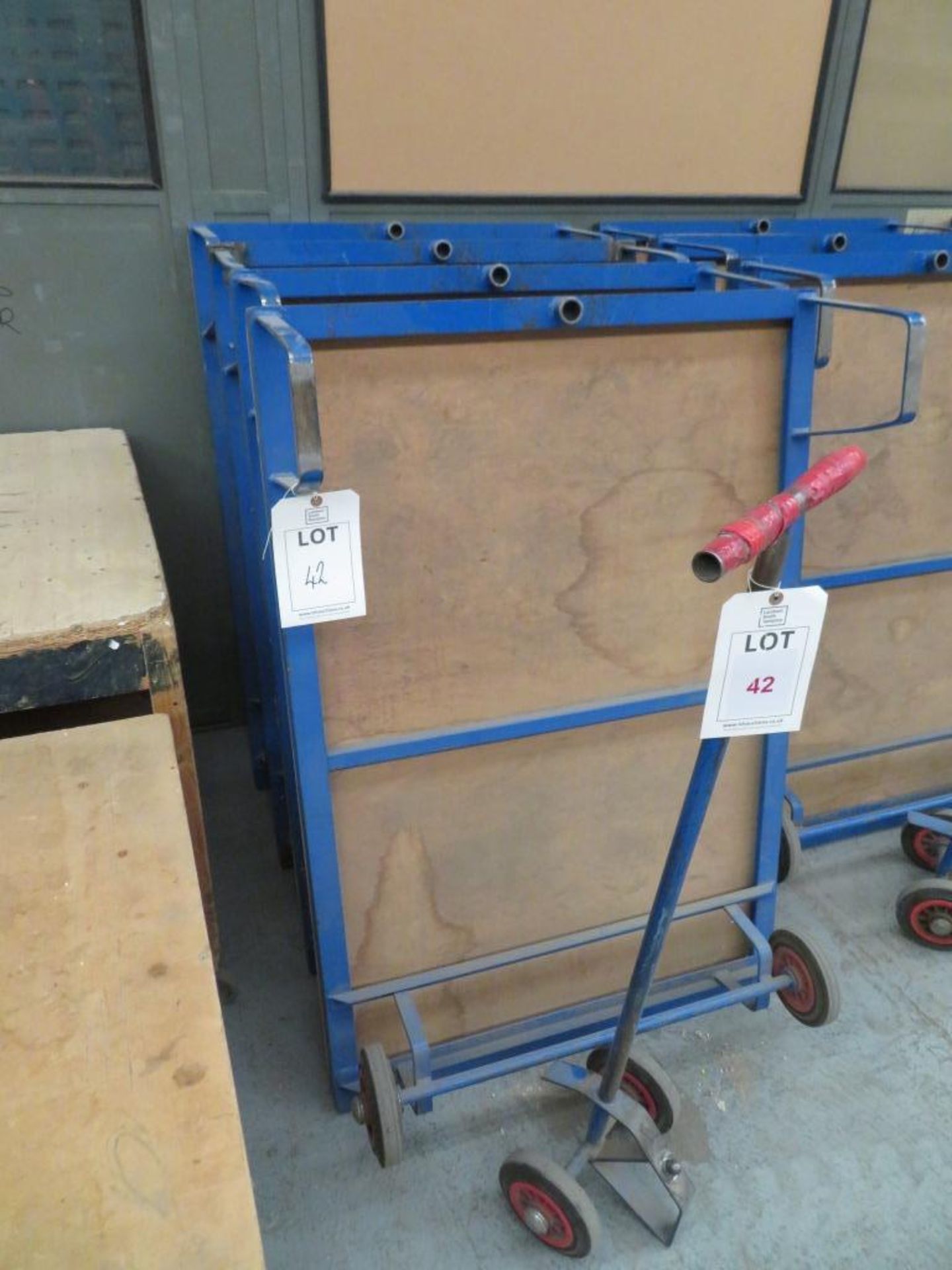 Four flat bed work trolleys with one handle