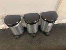 4 silver and black wastebins