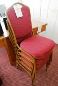 Four steel frame, red cloth upholstered stacking chairs