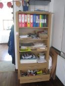 Wood effect storage unit with contents including pencils, colouring pencils, various books,