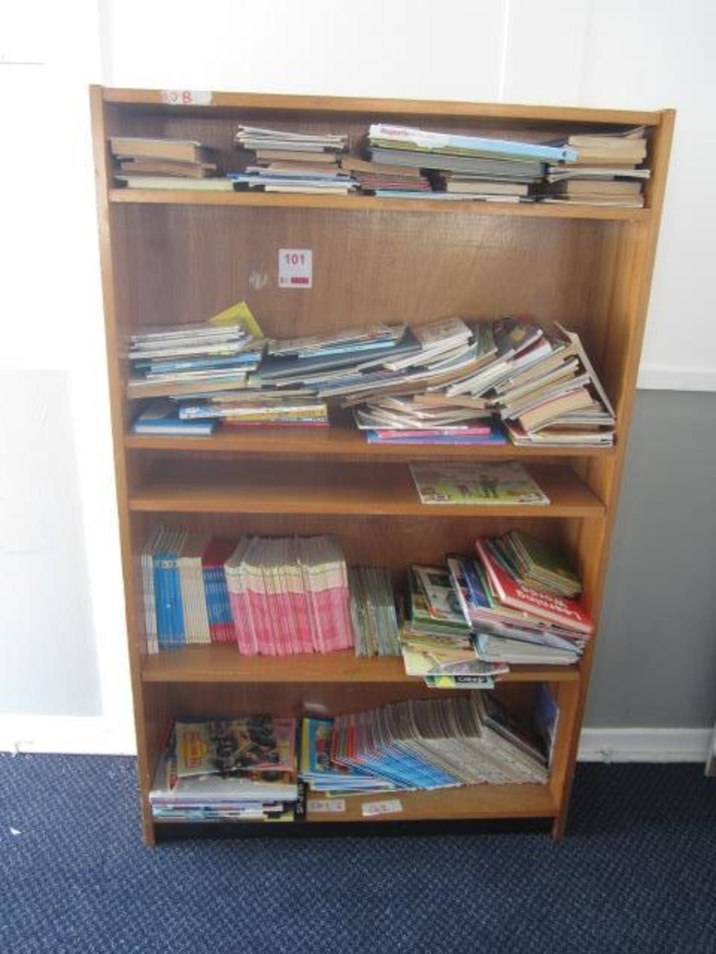 Wood effect bookcase with assorted books, teaching aids, board games, books etc.,Located at main