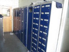 Nine metal personal lockers to include six 3 door, two 10 door, one dirty clothes locker
