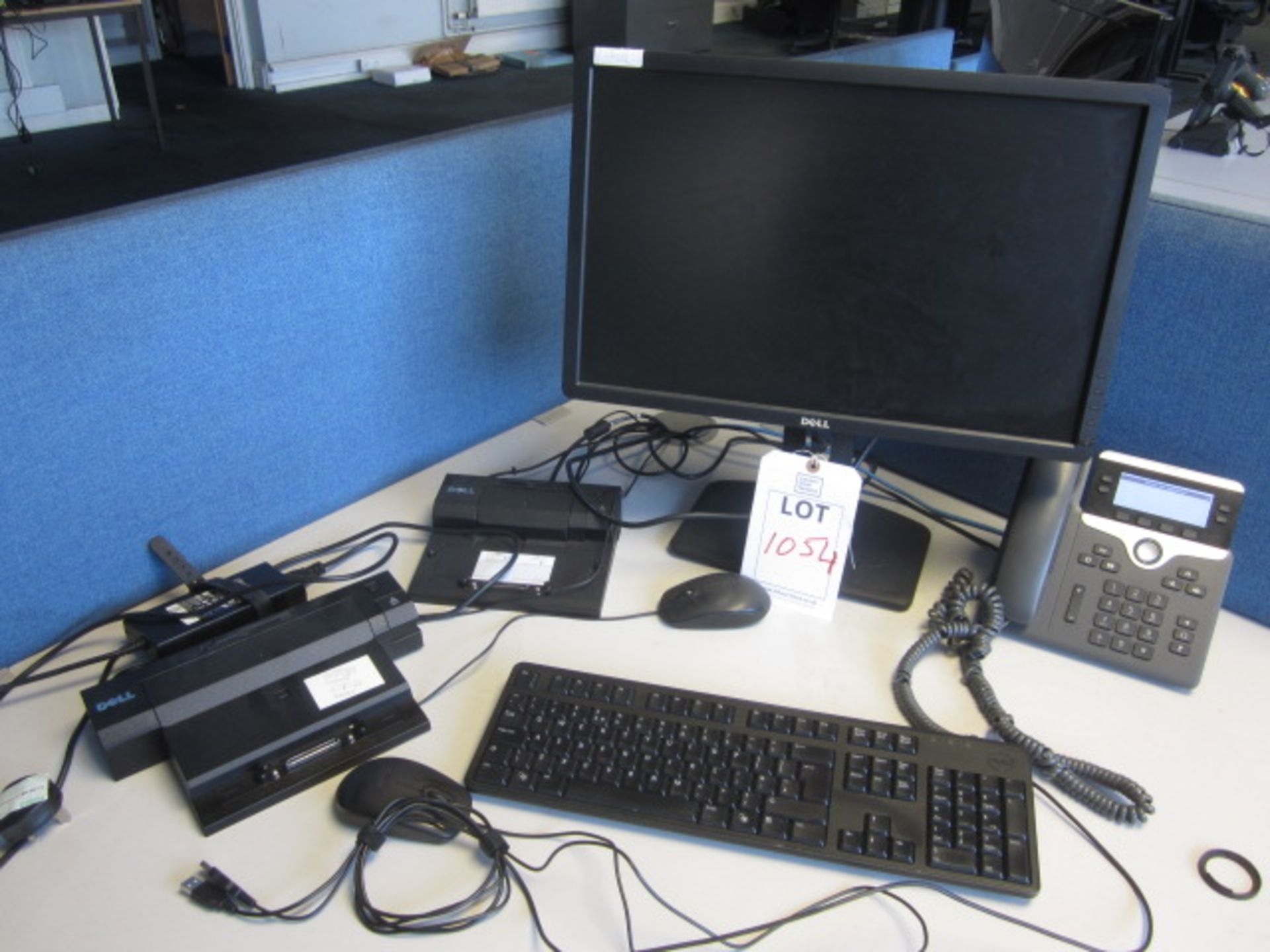 Three Dell docking station, three flat screen monitors, keyboard, two mouse