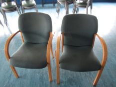 Two wood frame upholstered meeting chairs