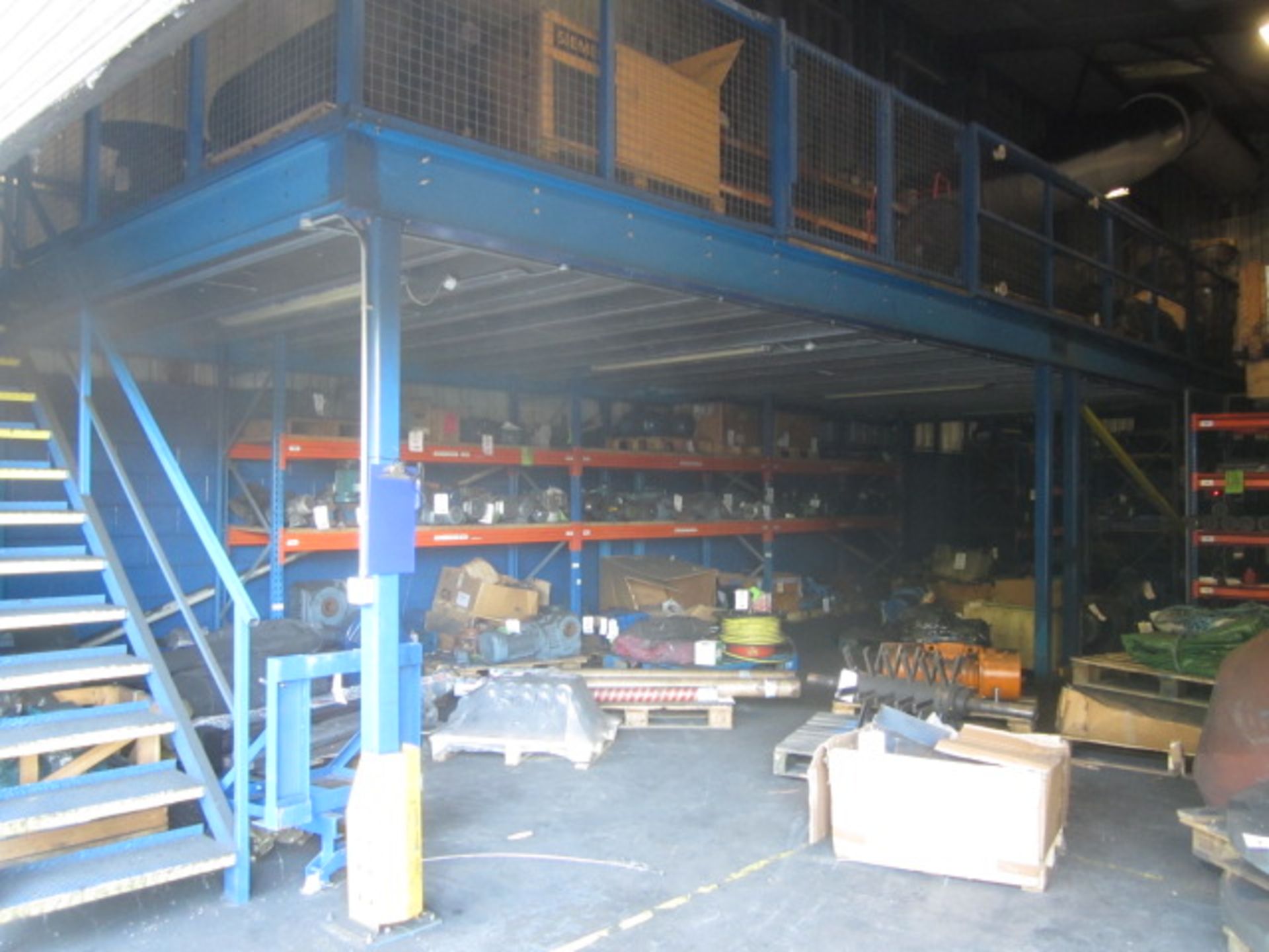 Freestanding mezzanine floor with forklift loading access point, safety fencing, two pedestrian