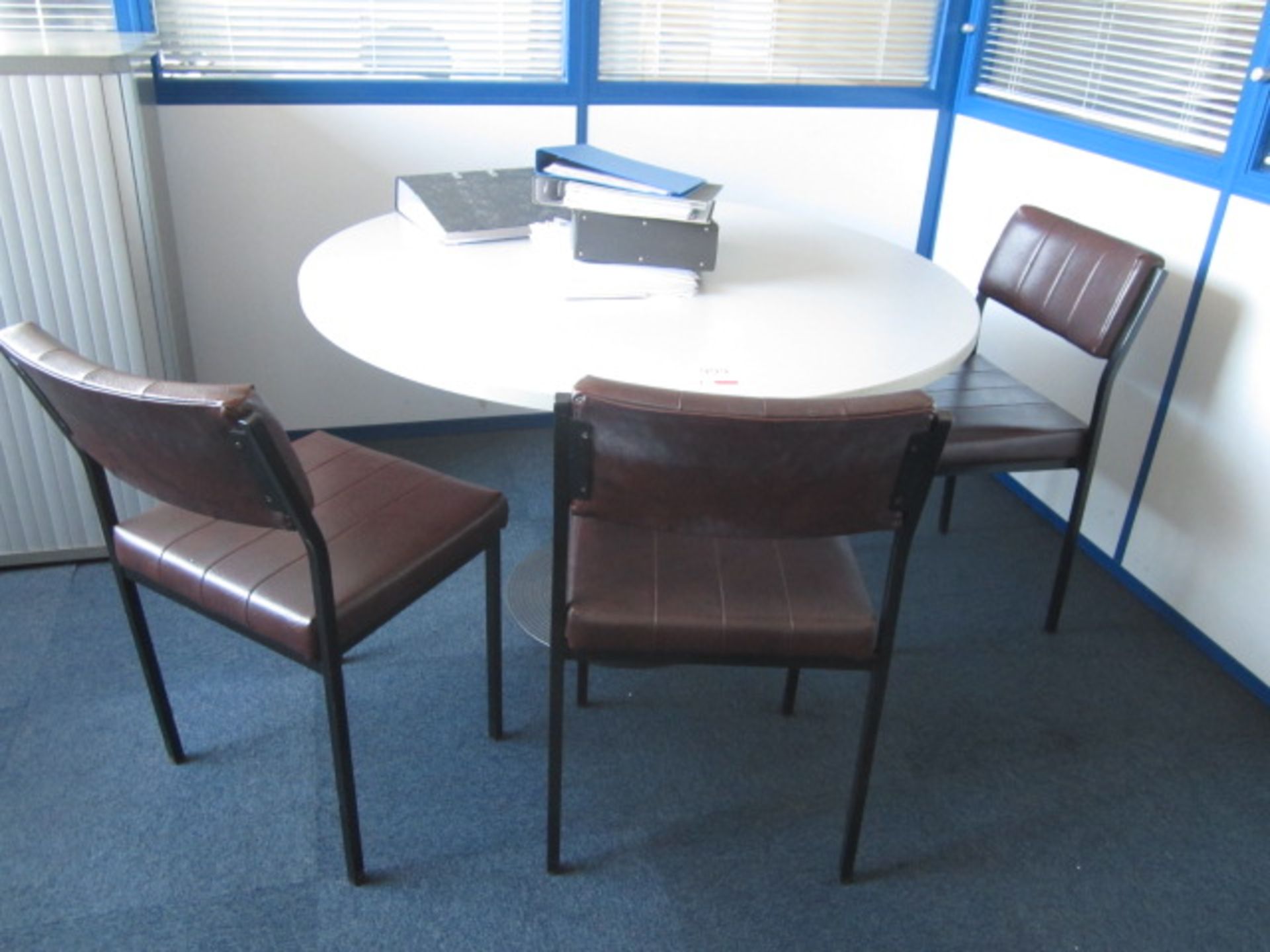 Grey melamine circular meeting table with four vinyl meeting chairs