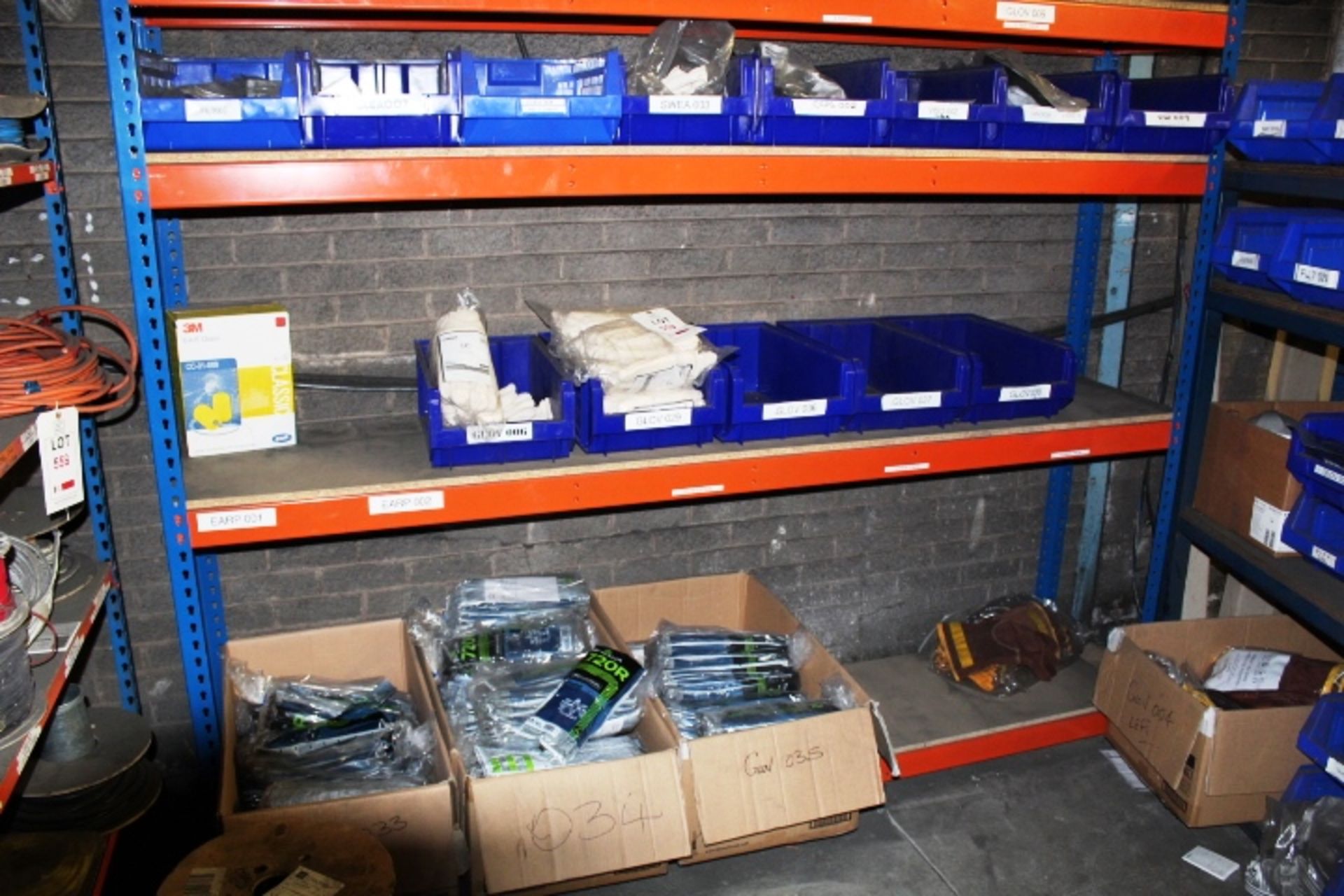 Three shelves of assorted PPE to include three boxes of Show A gloves, 5 bays of UCI gloves, UVEX