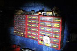 Three red wall mounted component bin storage racks and contents of split pins, nuts, grease nipples,