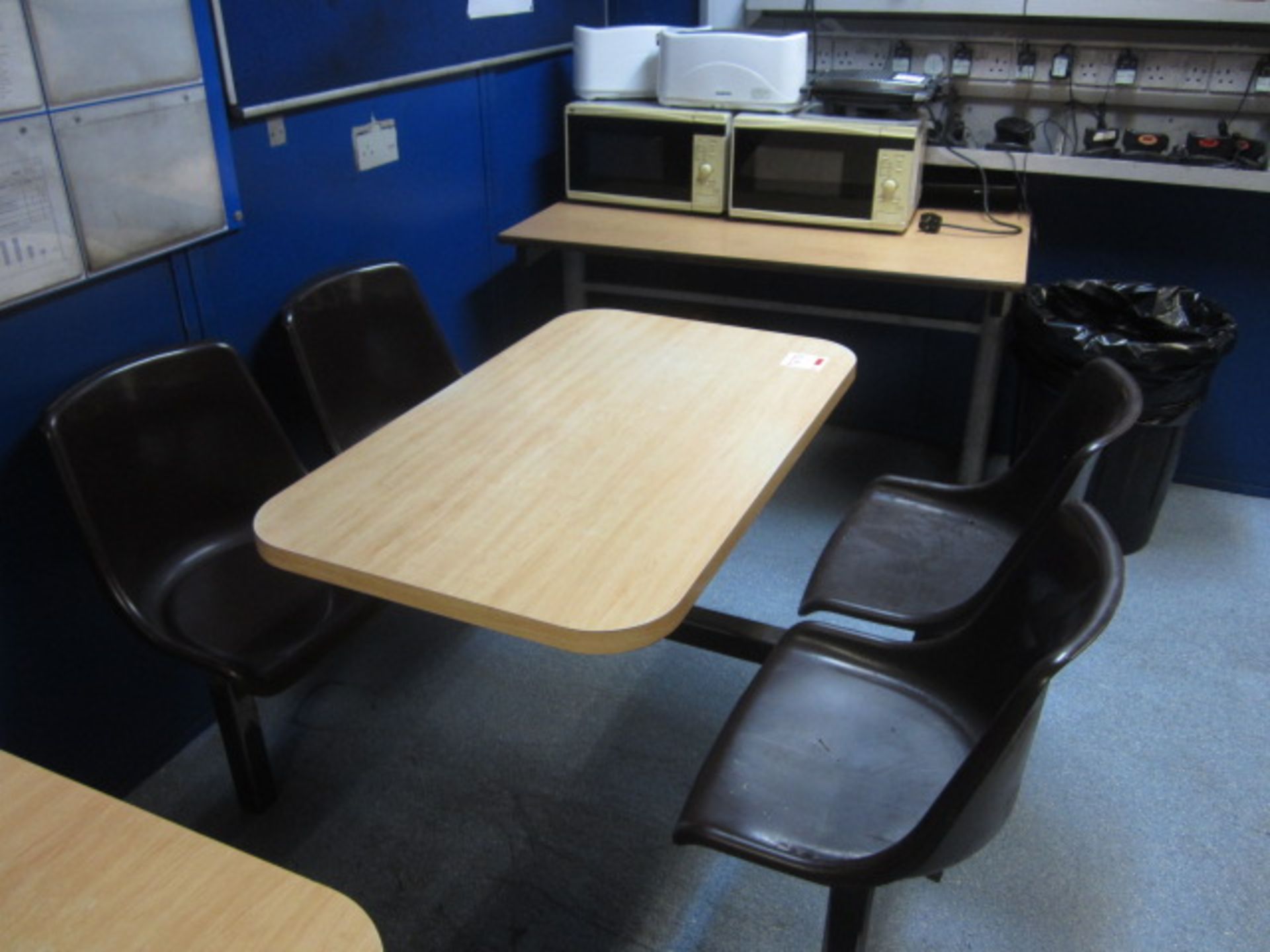 Two wood effect canteen tables with four fixed seats