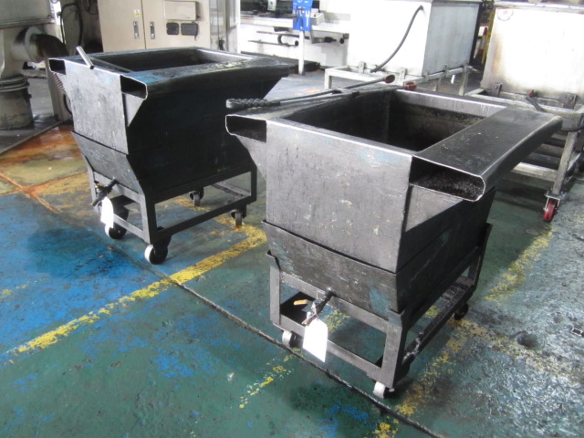 Two swarf bins mounted on mobile stand, with outlet pipe, 900 x 870mm