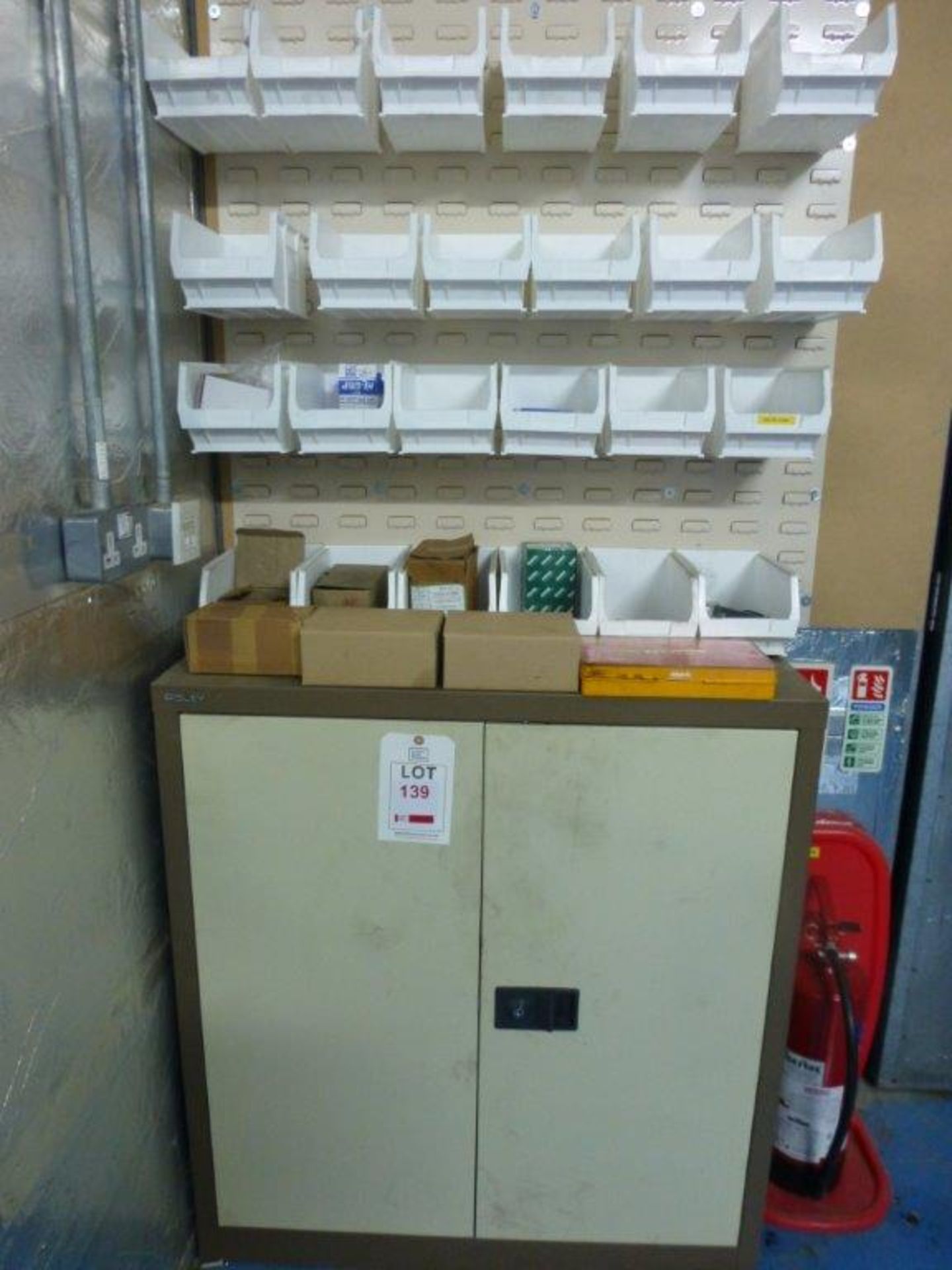 24 wall mounted plastic storage bins and steel double door cupboard including contents mainly