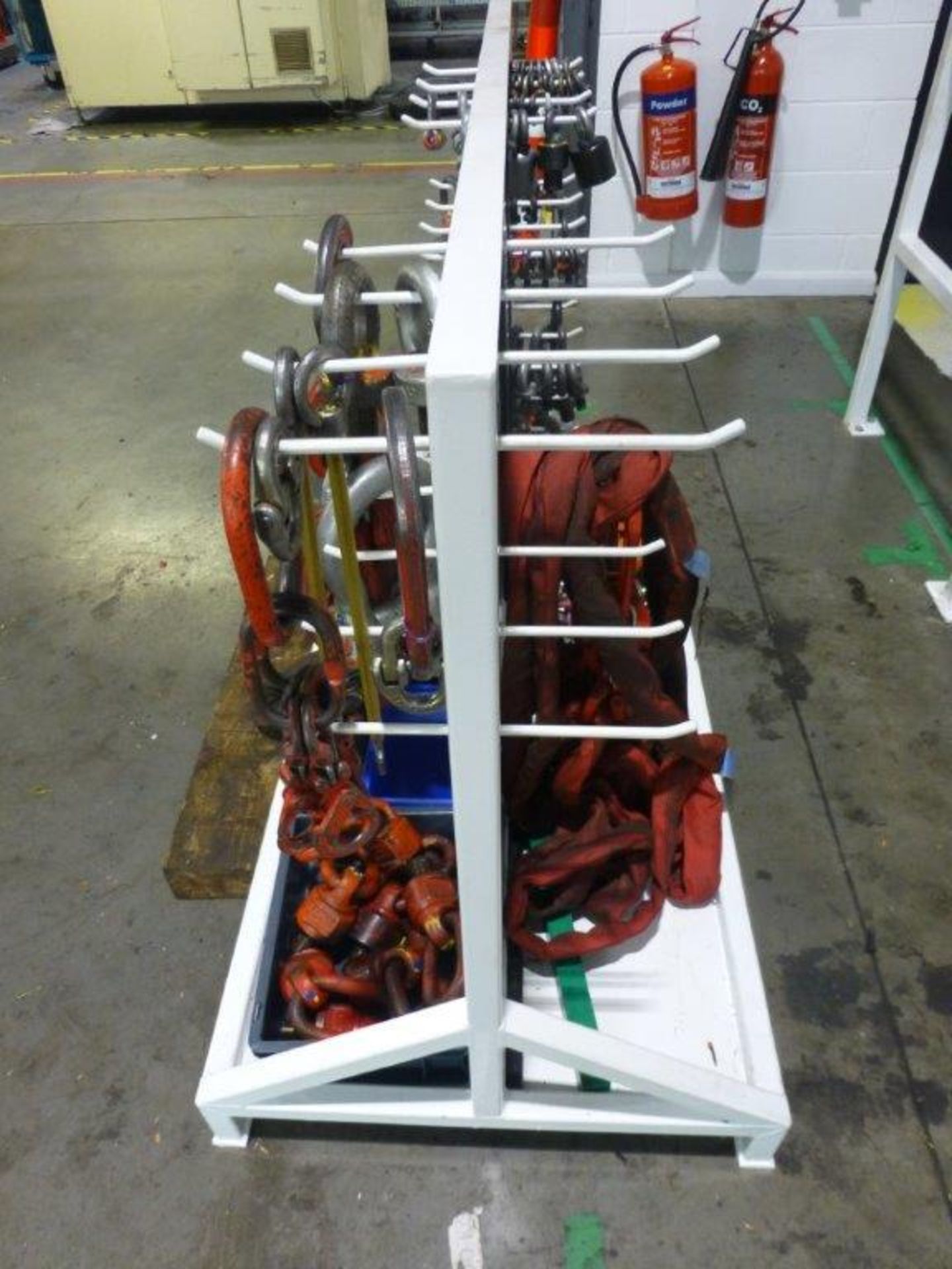 Quantity of lifting shackles, D-links, lifting eyes and slings on steel storage stand. Please note: