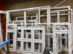 A quantity of approx 12 white window frames, plus a set of French Doors and Sliding patio door