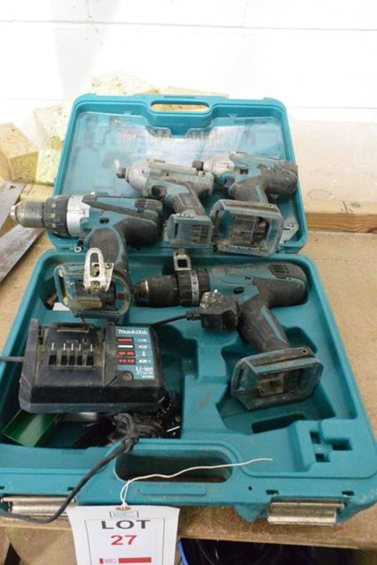 Three various Makita battery powered drills and one Erbauer battery powered drill, with charger &