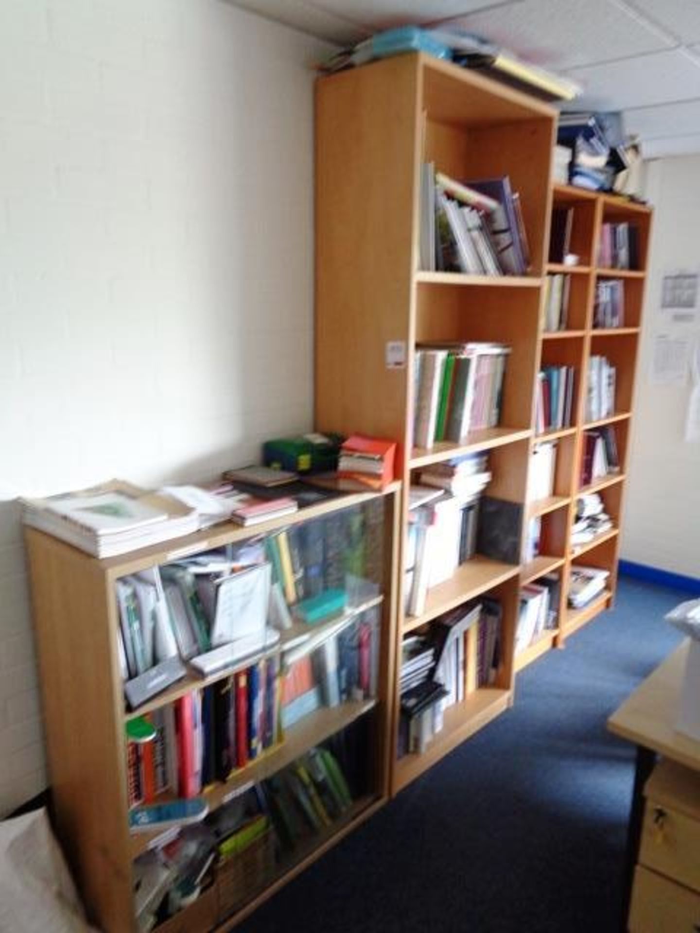 Three assorted light wood multi shelf cabinets and a light wood three shelf glass fronted cabinet