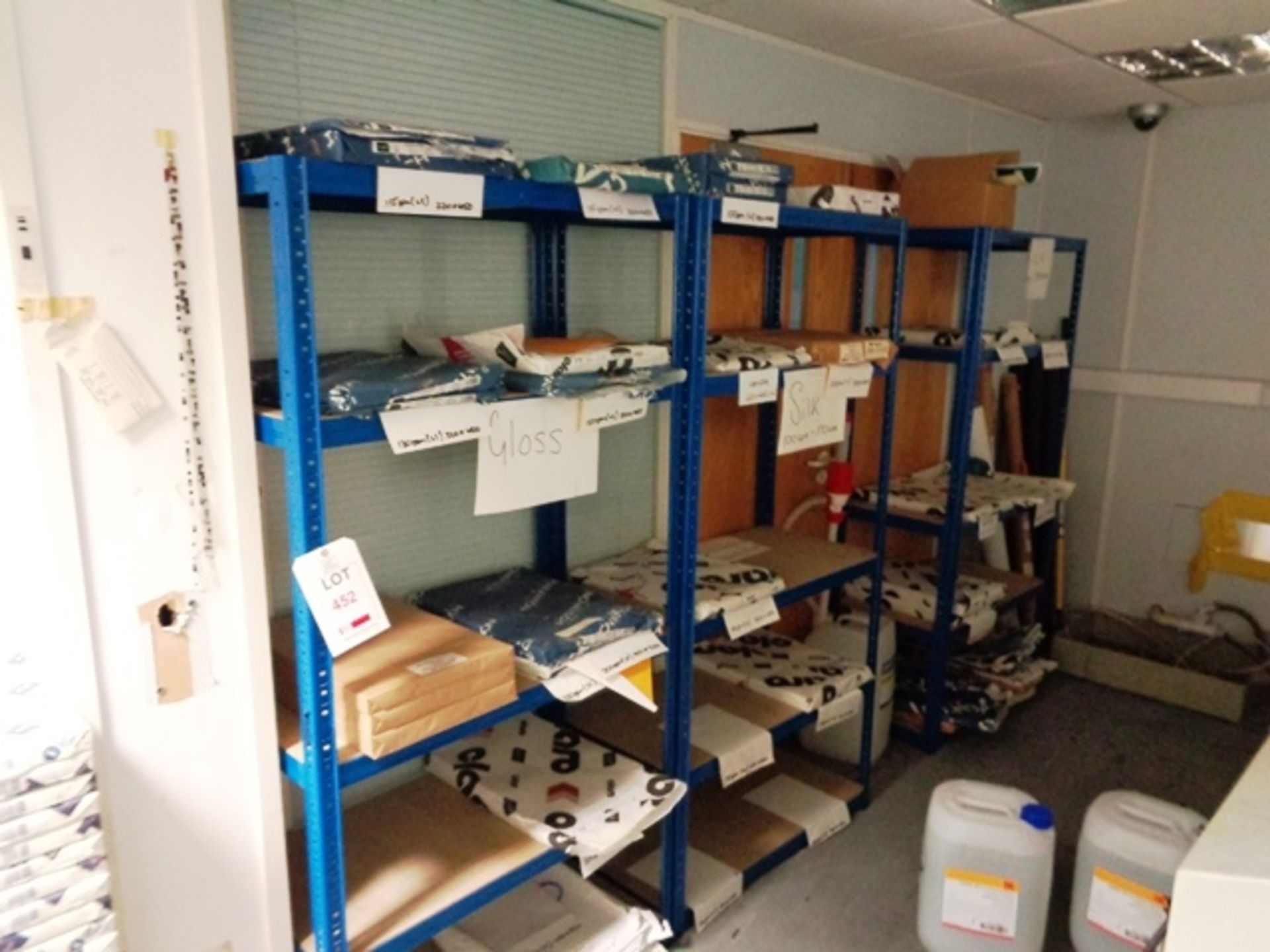 Three bays of blue adjustable stores shelving and quantity of assorted part used paper ream stock