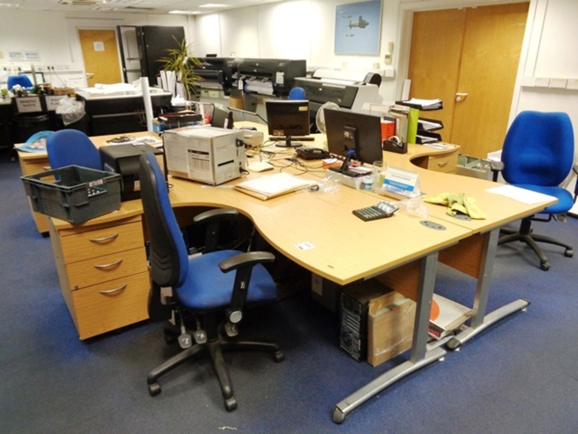 Four light wood effect L shaped office desks (1 x 4 section pod) with integrated 3-drawer pedestals,