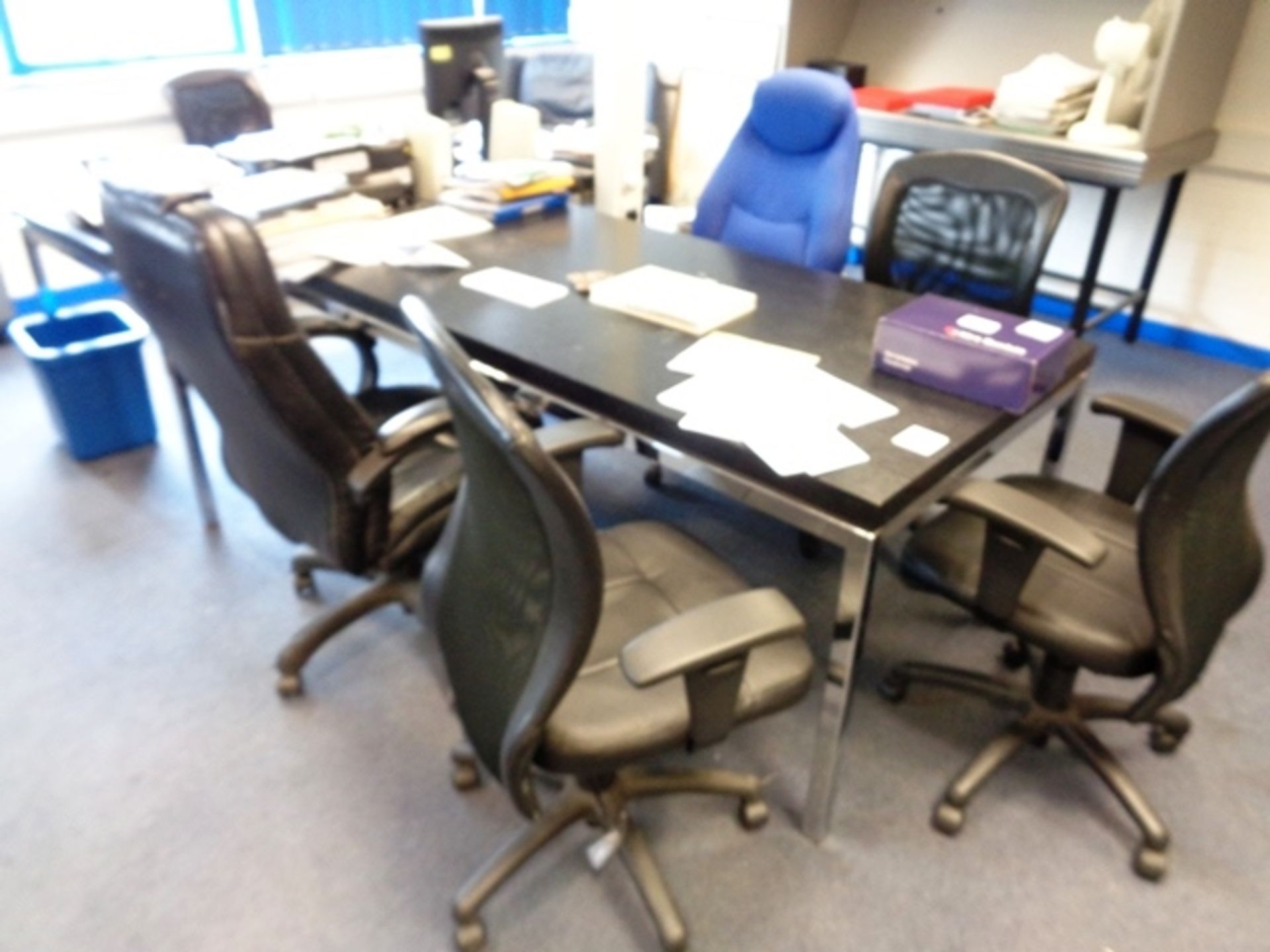 Two black laminate office tables, and six assorted swivel armchairs