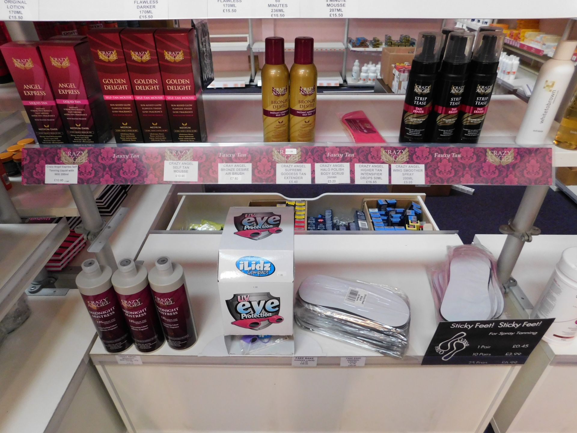 2 x Bays of shop display shelving and contents, including assortment of tanning products (tan - Image 3 of 5