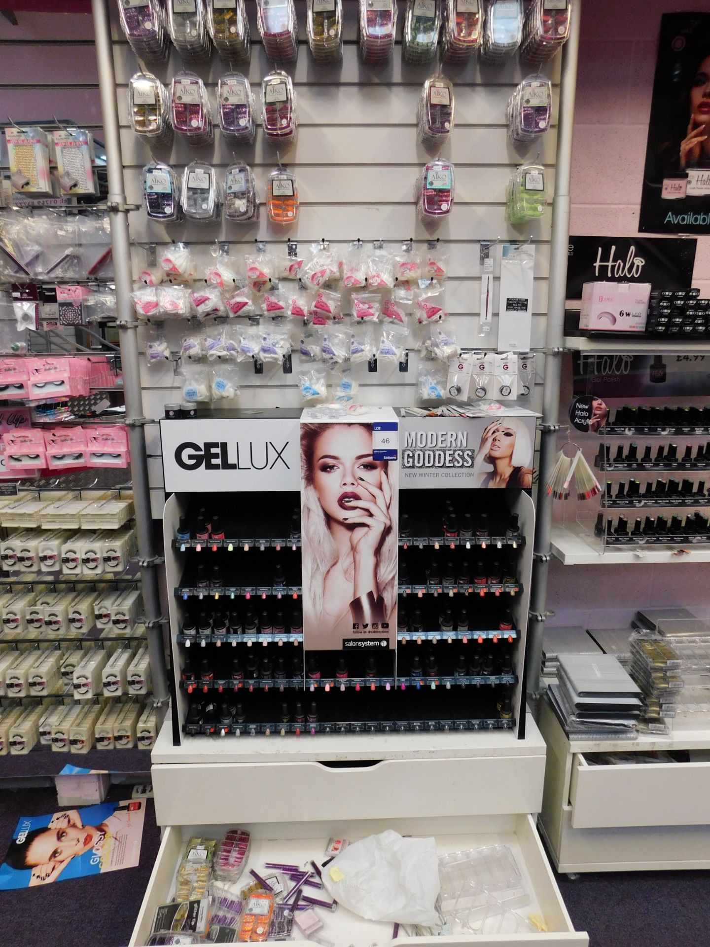 Assortment of nail polish, and nail tips, to wall display